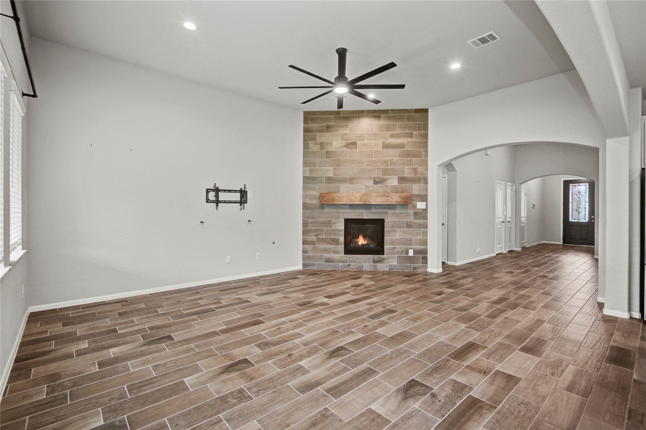 1314 Orchard Ridge Lane Tomball, TX 77375 - Photo 2 of 35 The spacious family room is anchored by a gas fireplace and enhanced by expansive windows for abundant natural light.