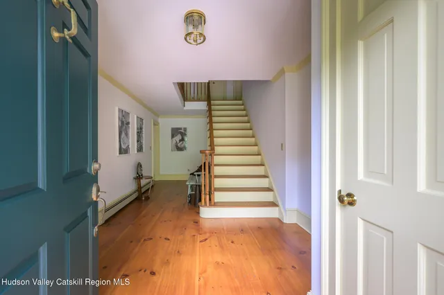 a view of entryway and hall with wooden floor