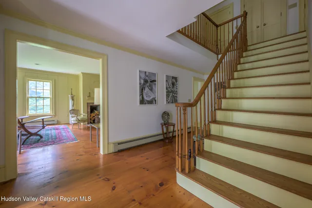 a view of entryway and hall with wooden floor