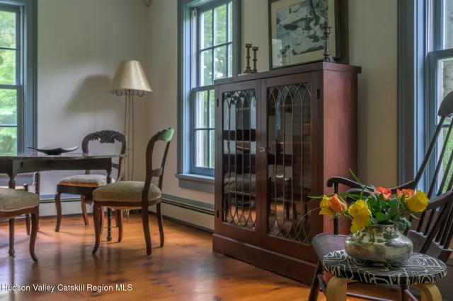 a dining room with furniture and wooden floor