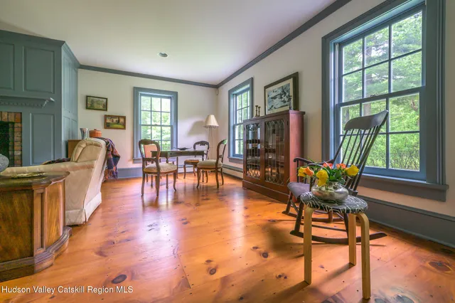 a living room with furniture and floor to ceiling windows