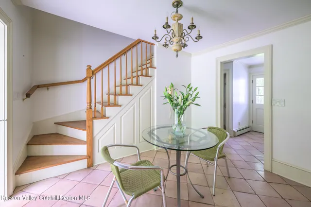 a dining room with furniture and a chandelier