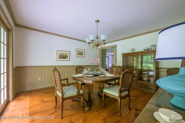 a view of a dining room with furniture and a chandelier