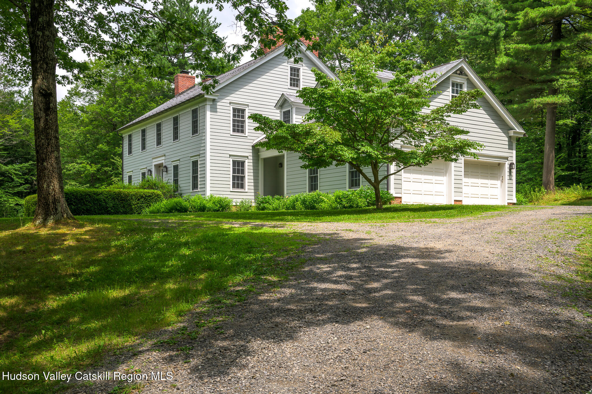 7 Partridge Drive Austerlitz, NY 12017 - Photo 3 of 46 a view of a house next to a yard with plants and large trees