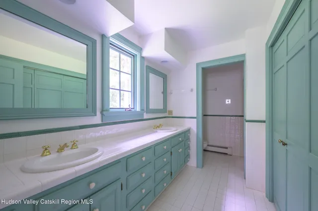 a bathroom with a tub sink and mirror