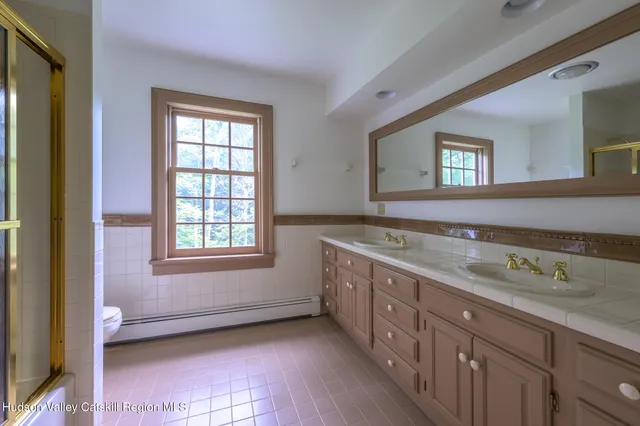 a view of a kitchen with a sink a window and a wooden floor