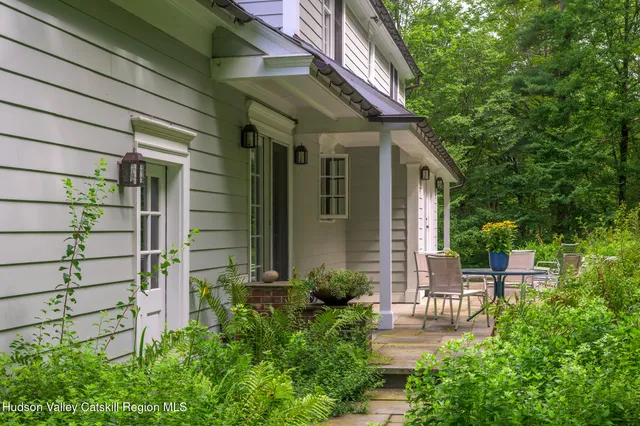 a view of a chair and table in the patio with plants