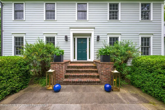 a view of a house with sitting area and potted plants