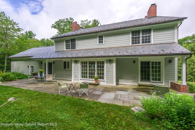 a front view of a house with patio and garden