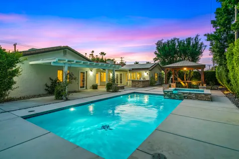 a view of a swimming pool with a yard