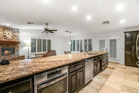 a kitchen with stainless steel appliances granite countertop a stove and a sink