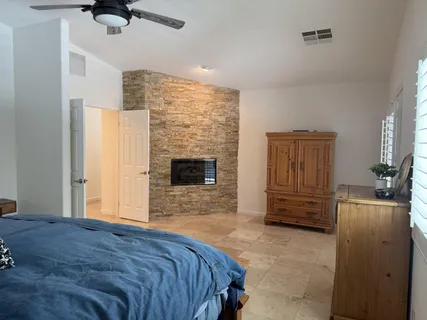 a bedroom with a bed and a television