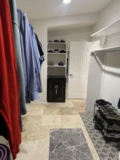 a view of an empty room with furniture and a fireplace