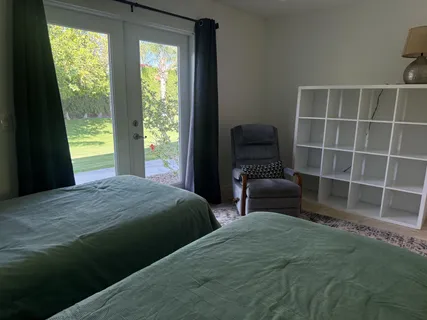 a bedroom with a bed and a chair