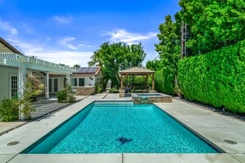 a view of house with backyard outdoor seating and green space