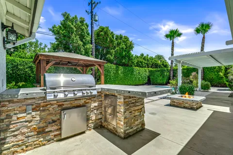 a view of a patio with couches table and chairs with potted plants