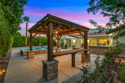 a view of a patio with swimming pool table and chairs