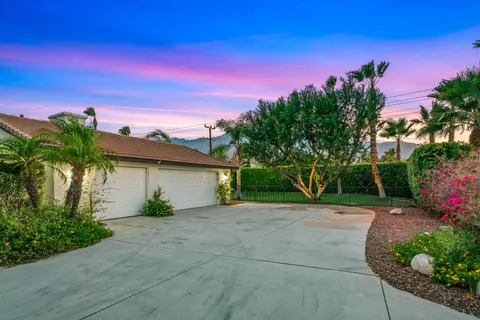a front view of a house with a yard and a garage