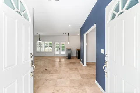 a view of a hallway with wooden shelves
