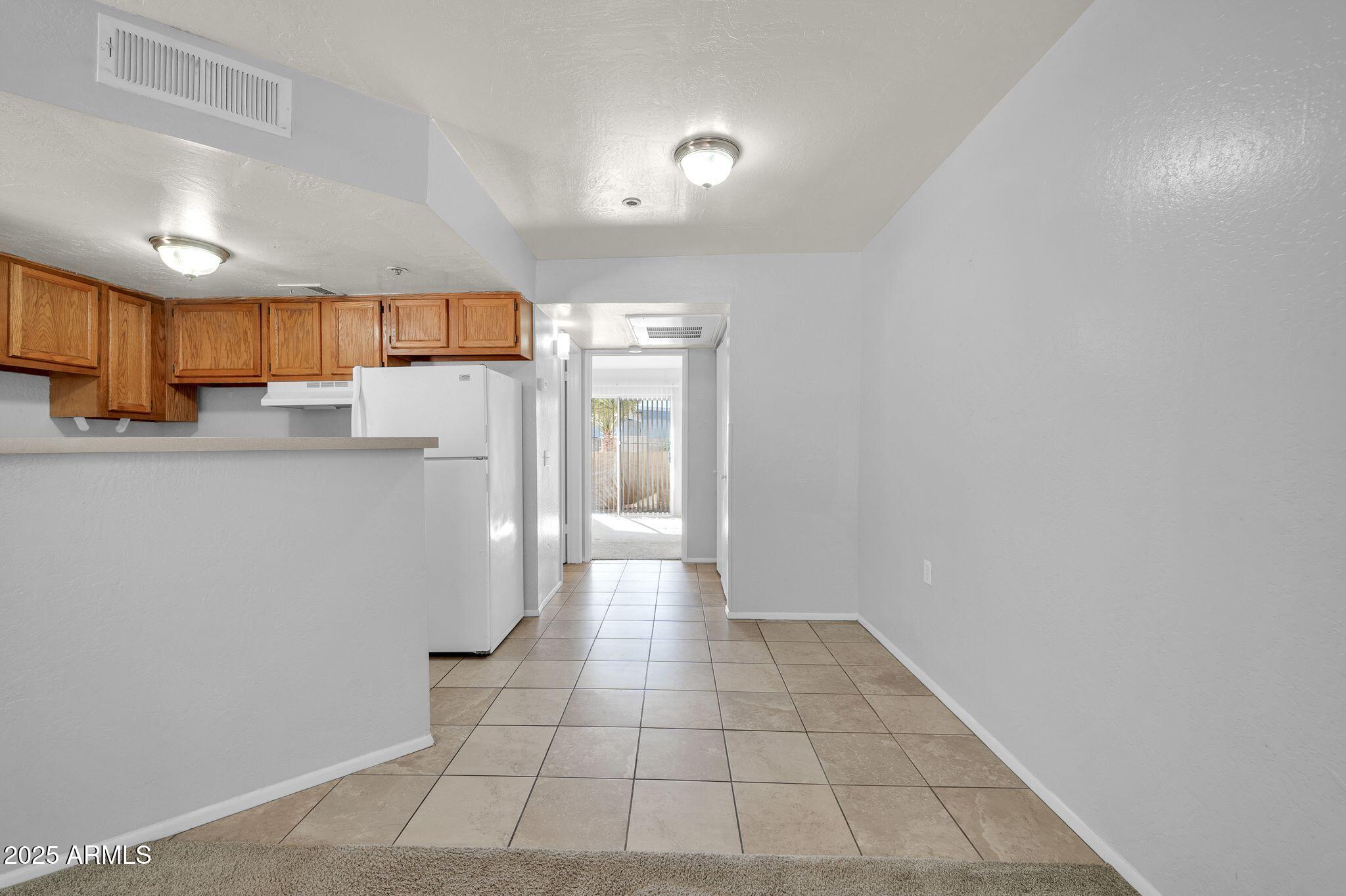 12221 West Bell Road, Unit 187 Surprise, AZ 85378 - Photo 3 of 11 a view of a refrigerator in kitchen and a window