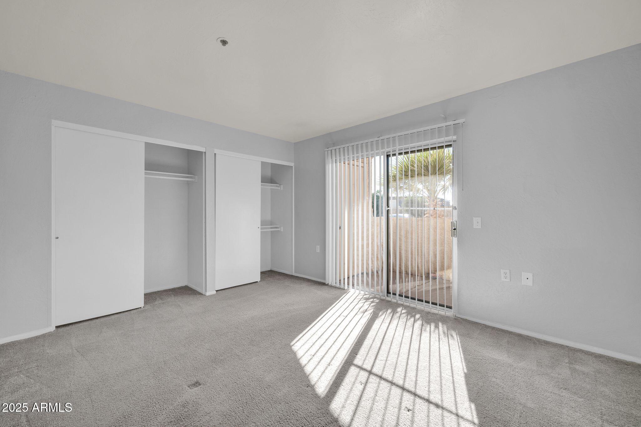 12221 West Bell Road, Unit 187 Surprise, AZ 85378 - Photo 5 of 11 a view of an empty room with glass door