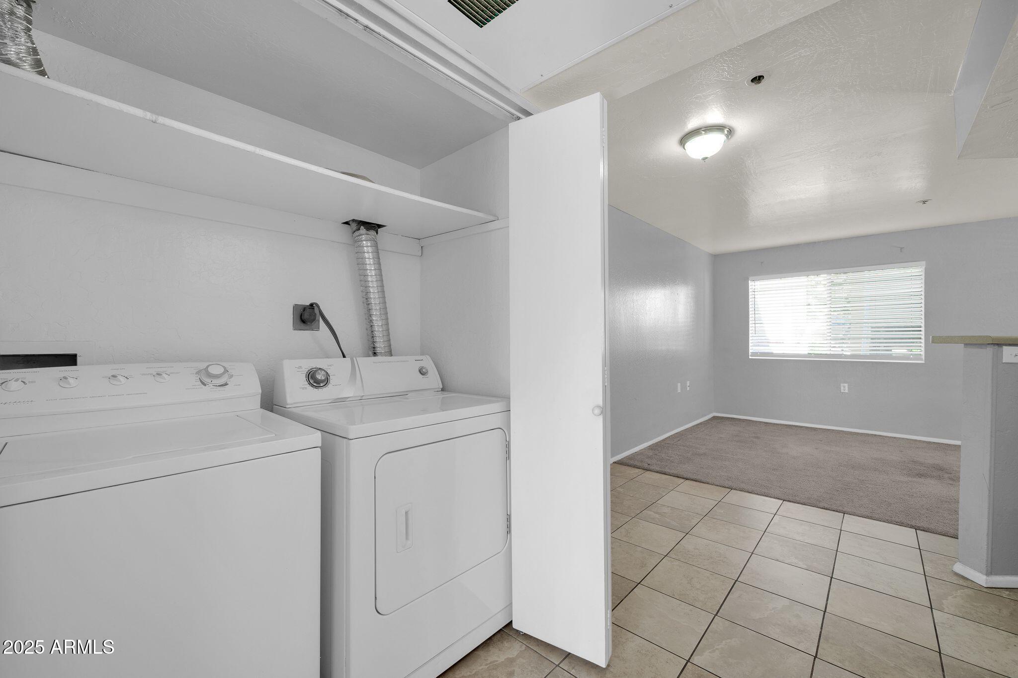 12221 West Bell Road, Unit 187 Surprise, AZ 85378 - Photo 6 of 11 a view of storage and utility room with washer and dryer