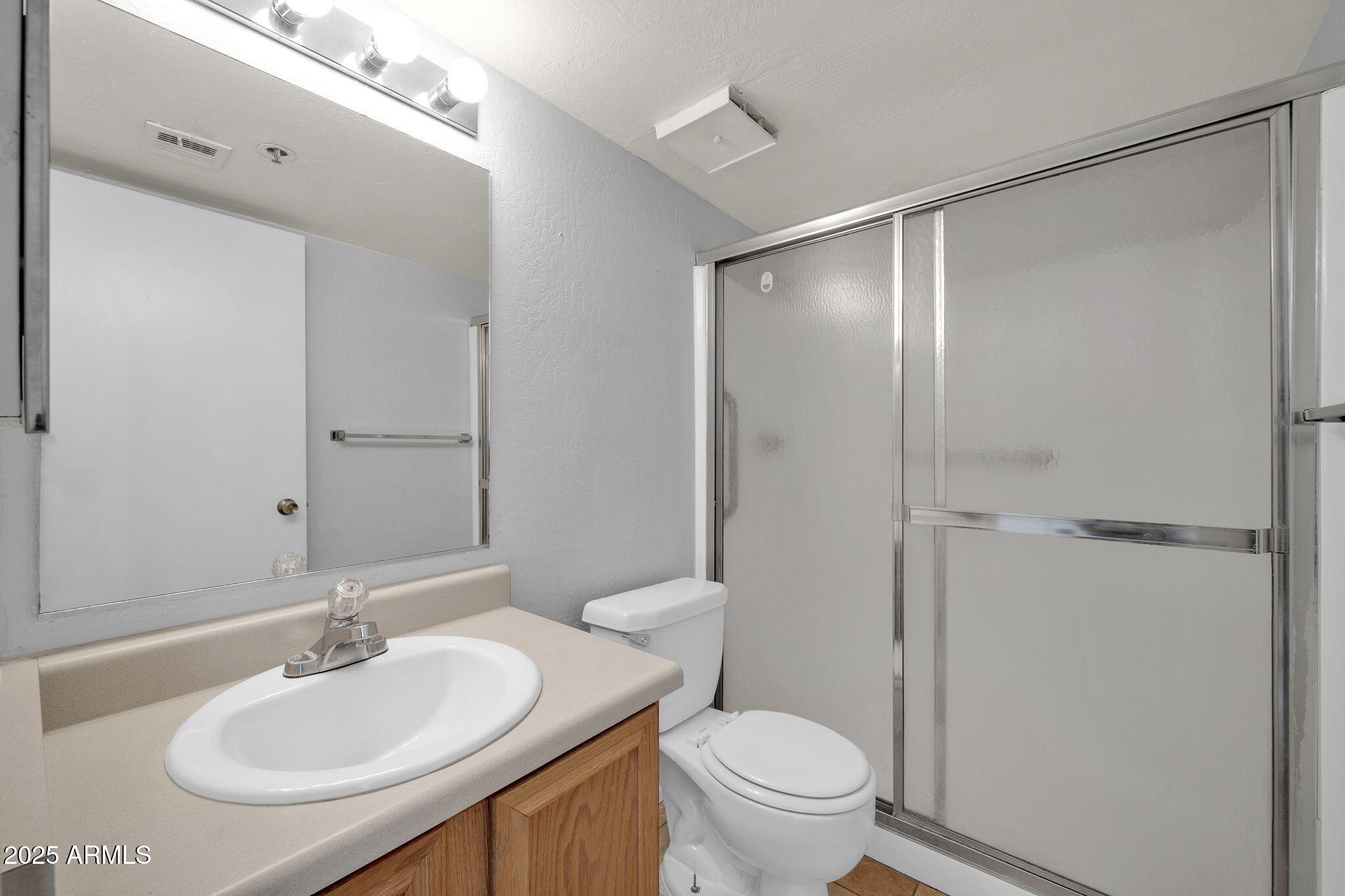 12221 West Bell Road, Unit 187 Surprise, AZ 85378 - Photo 7 of 11 a bathroom with a sink toilet and shower