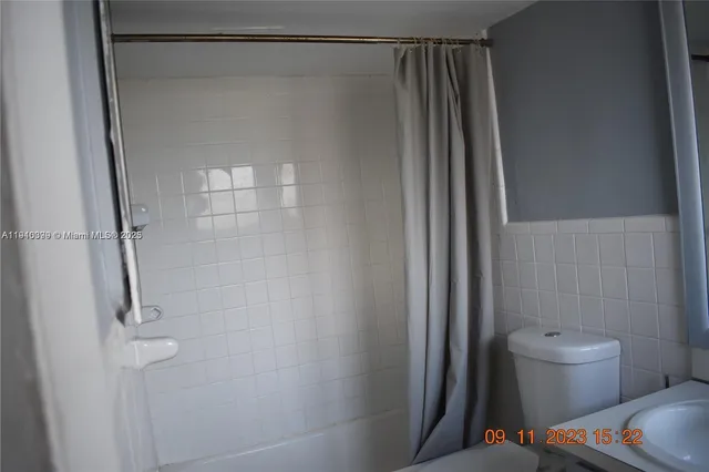 a bathroom with a shower and a toilet