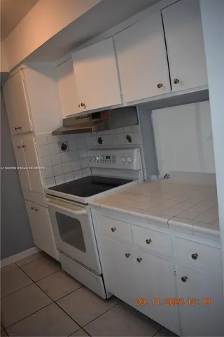 a stove top oven sitting inside of a kitchen