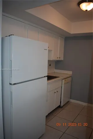 a utility room with cabinets washer and dryer