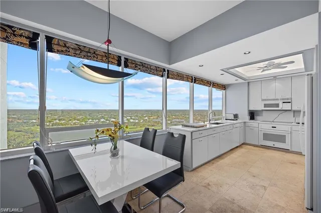 a kitchen with kitchen island a large window in it