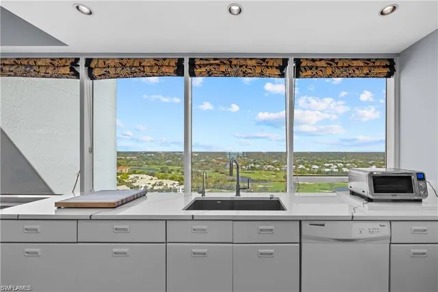 a sink with a window and view of living room