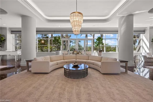 a living room with fireplace furniture and a large window