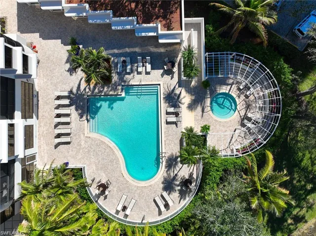 an aerial view of a house with garden space and swimming pool