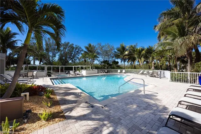 a view of a swimming pool with a patio and a yard