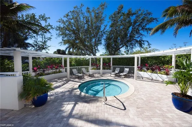 a swimming pool with outdoor seating and patio