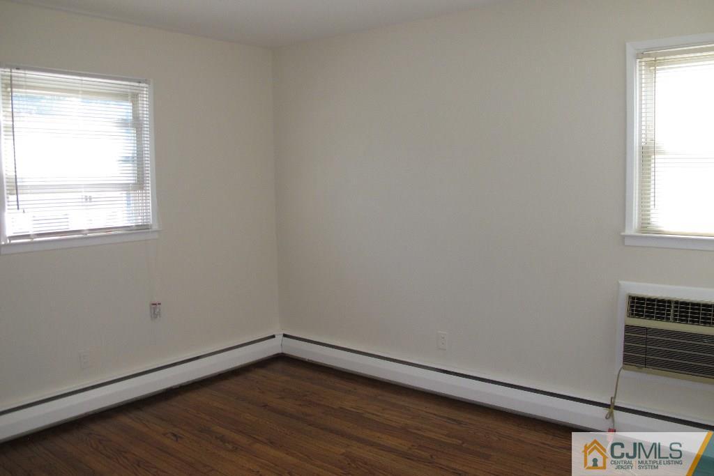 95 Brandywine Road Fords, NJ 08863 - Photo 10 of 23 an empty room with wooden floor and windows
