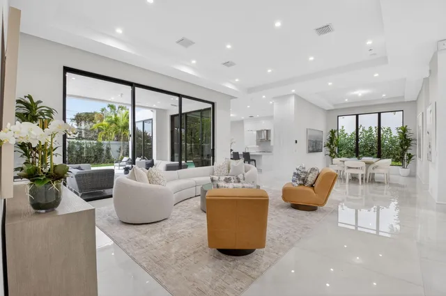 a living room with patio furniture and a flat screen tv