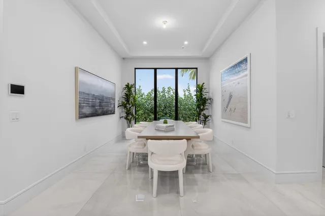 a kitchen with kitchen island a stove a table and chairs in it