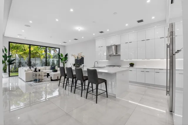 a kitchen with stainless steel appliances kitchen island granite countertop a sink and cabinets