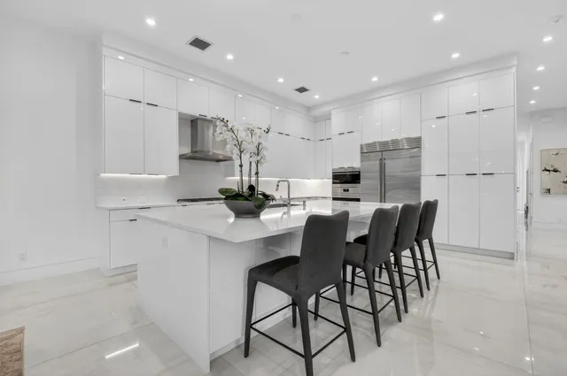 a bathroom with a granite countertop sink a toilet and shower