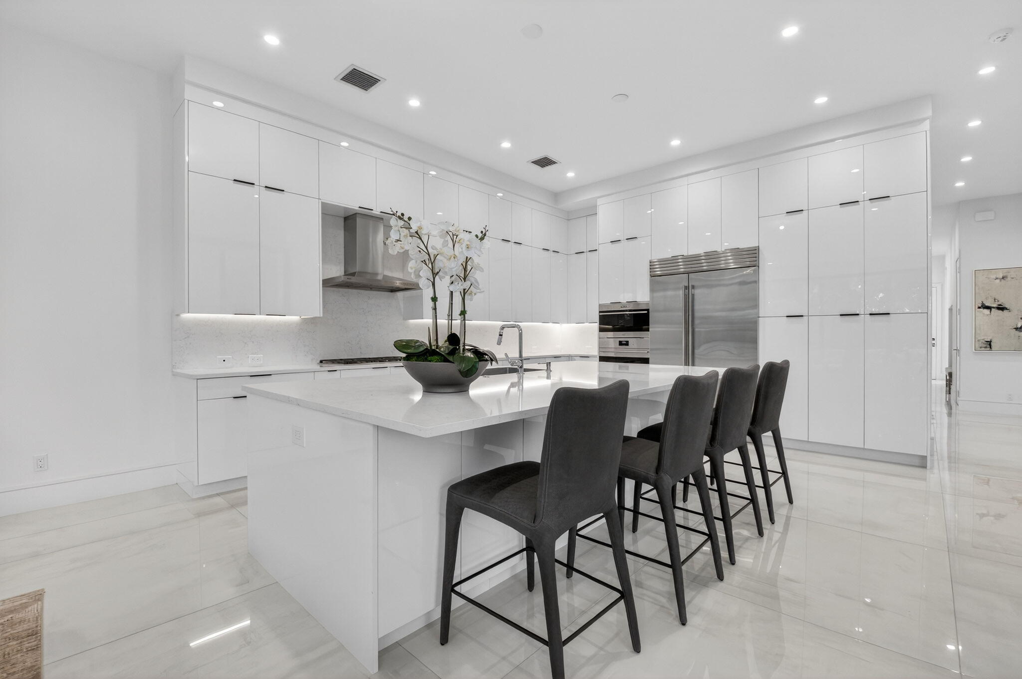 2232 Delray Ridge Lane Delray Beach, FL 33444 - Photo 26 of 68 a kitchen with kitchen island a stove a table and chairs in it