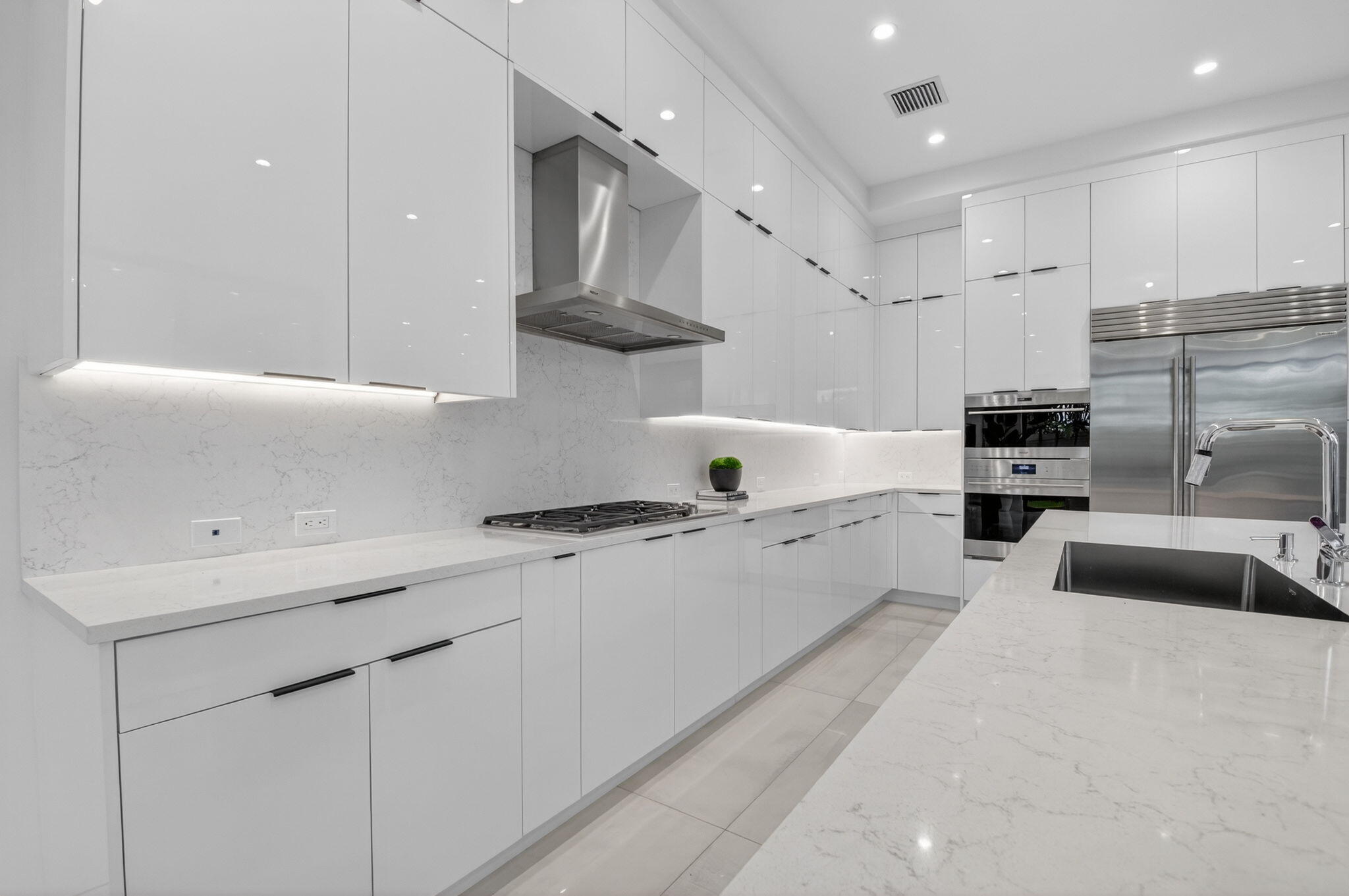 2232 Delray Ridge Lane Delray Beach, FL 33444 - Photo 27 of 68 a kitchen with stainless steel appliances granite countertop a sink stove and refrigerator