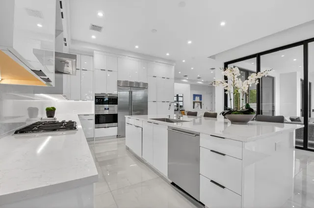 a living room with furniture large window and a fireplace
