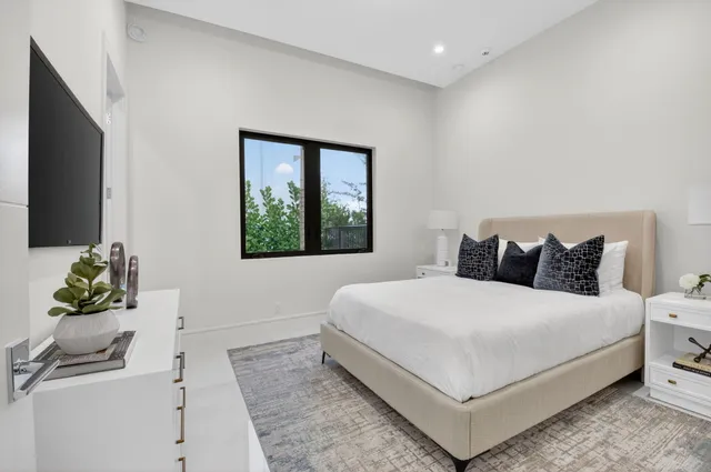a living room with furniture a large window and a flat screen tv