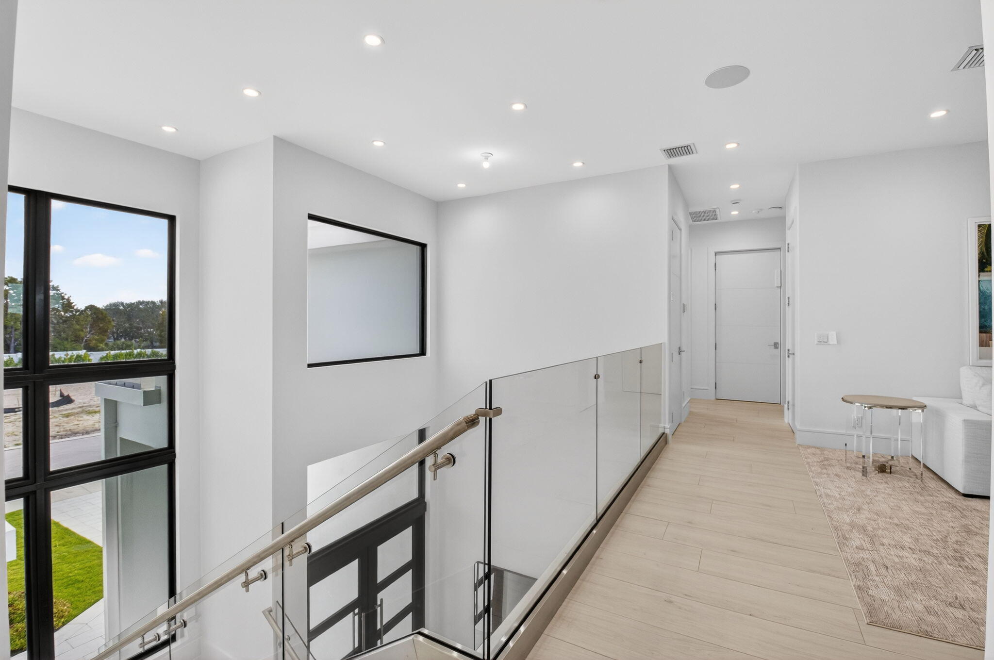 2232 Delray Ridge Lane Delray Beach, FL 33444 - Photo 38 of 68 a view of a hallway with wooden floor and windows