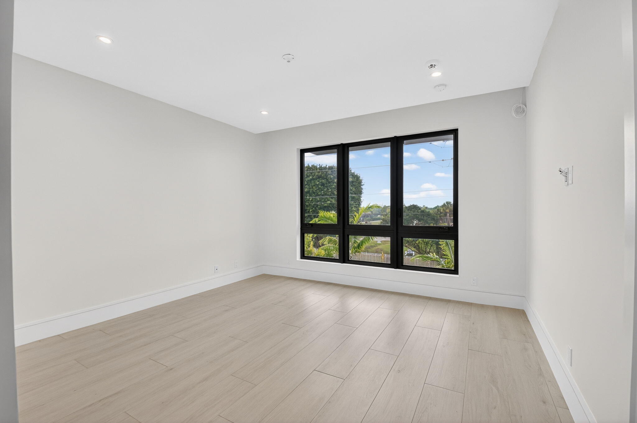 2232 Delray Ridge Lane Delray Beach, FL 33444 - Photo 42 of 68 an empty room with wooden floor and windows