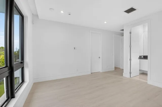 a spacious bathroom with a granite countertop sink and a mirror