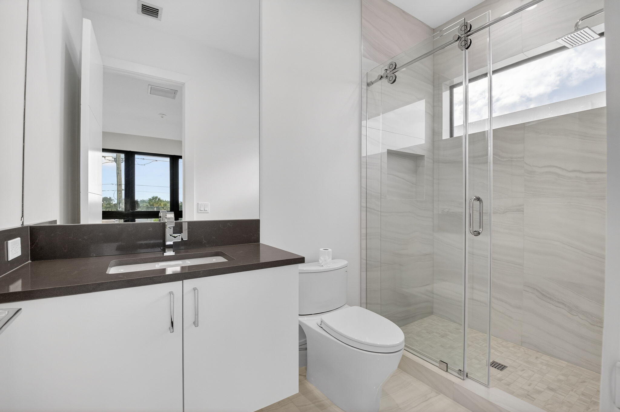 2232 Delray Ridge Lane Delray Beach, FL 33444 - Photo 44 of 68 a bathroom with a granite countertop sink a toilet and shower