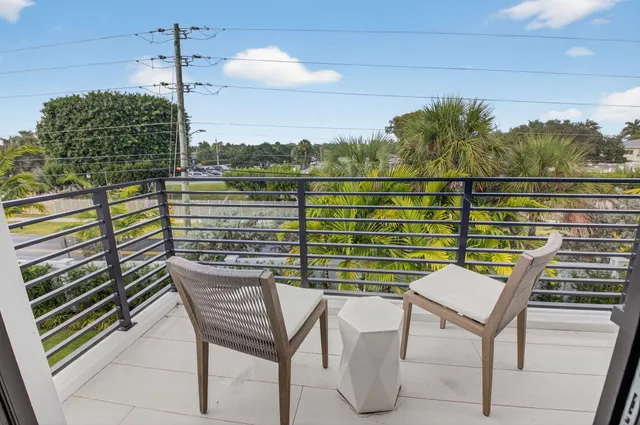 a front view of a house with a garden and plants